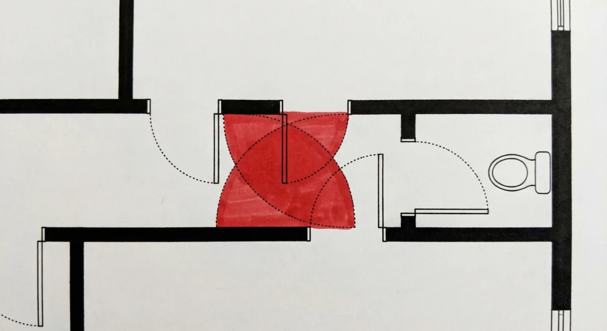 Floor plan detail showing two hallway doors whose swing arcs collide, with red highlight marking the conflict zone